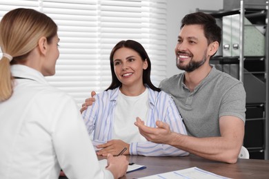 Couple having appointment with fertility doctor in clinic. Patient consultation