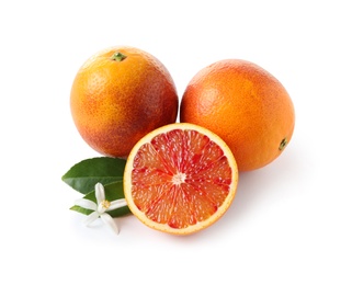 Photo of Ripe blood oranges, leaves and flower on white background. Citrus fruit