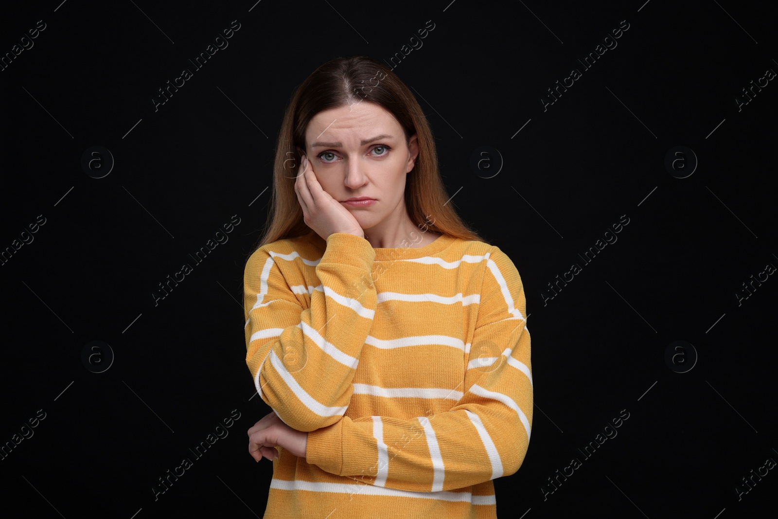 Photo of Portrait of sad woman on black background