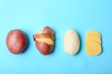 Photo of Flat lay composition with fresh organic potatoes on color background