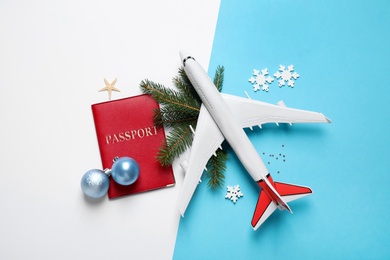 Photo of Flat lay composition with Christmas decorations and passport on color background. Winter vacation