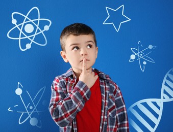 Image of Thoughtful little boy on blue background with different drawings