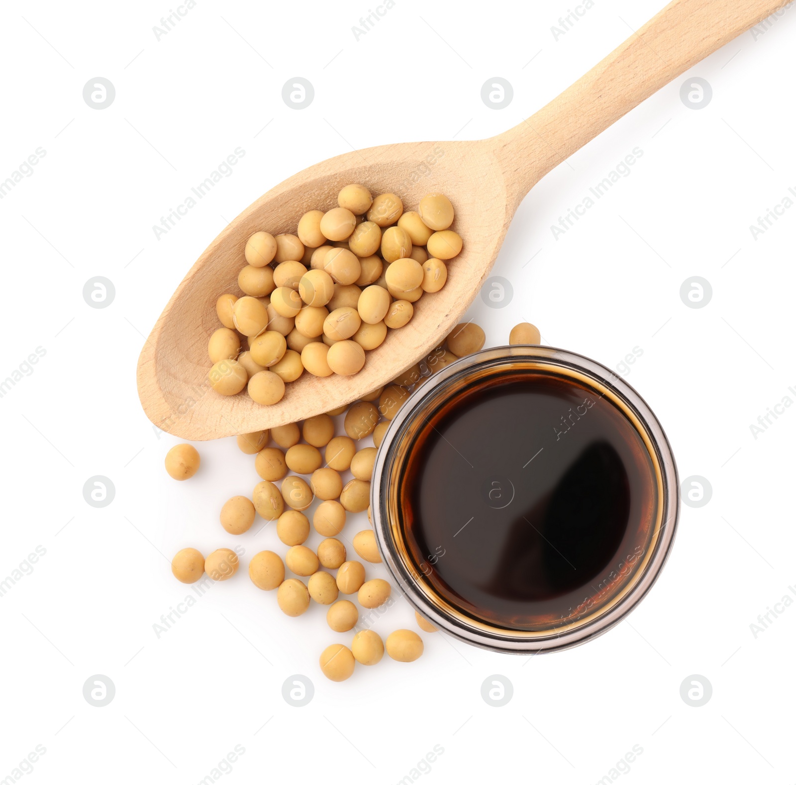 Photo of Bowl of soy sauce and soybeans isolated on white, top view