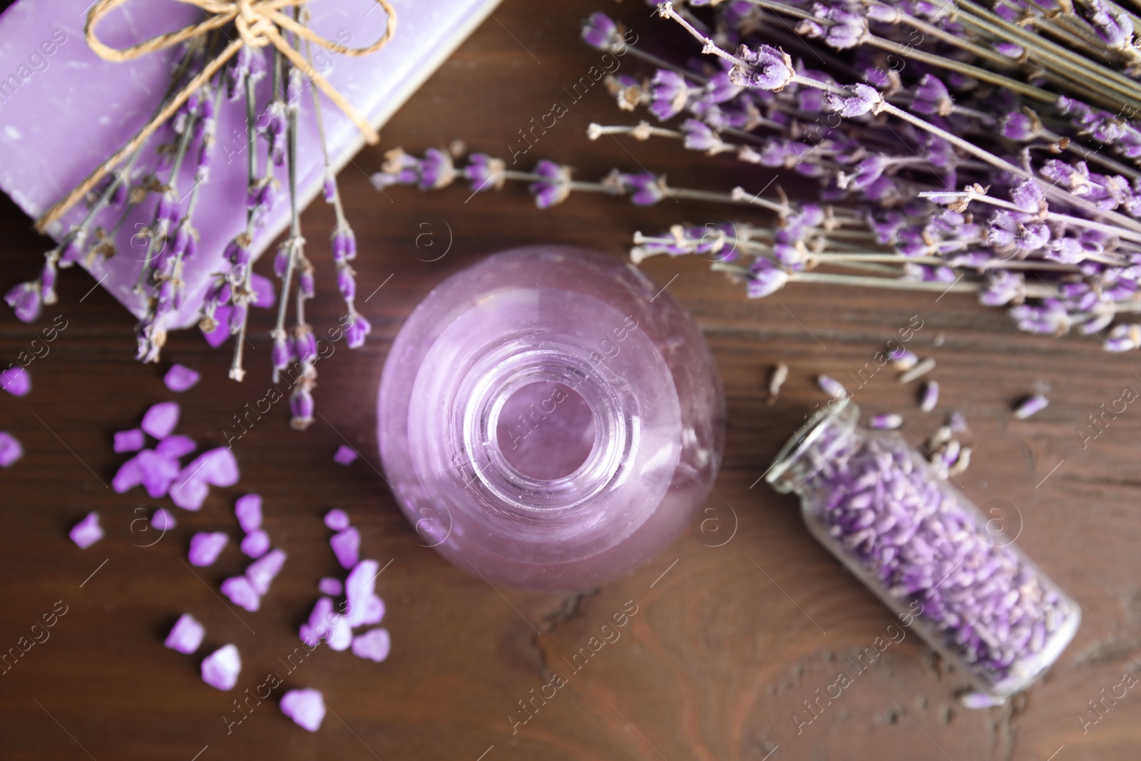 Photo of Flat lay composition with aromatic lavender oil on wooden background