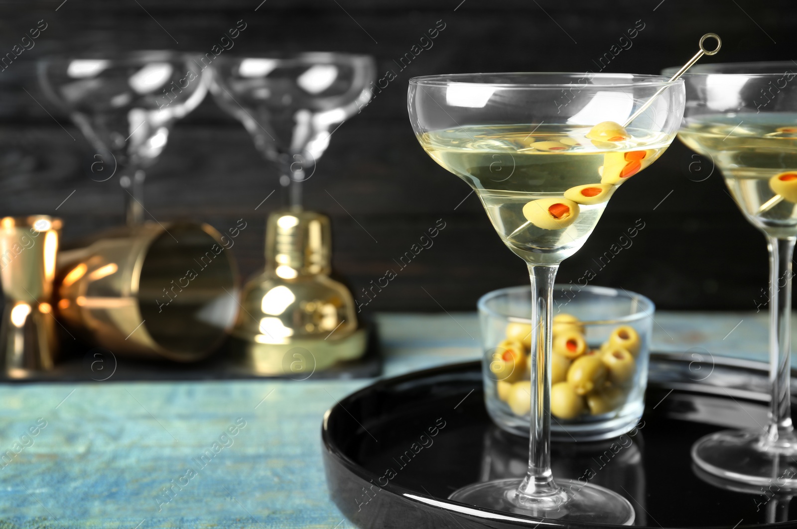 Photo of Glasses of Classic Dry Martini with olives on wooden table