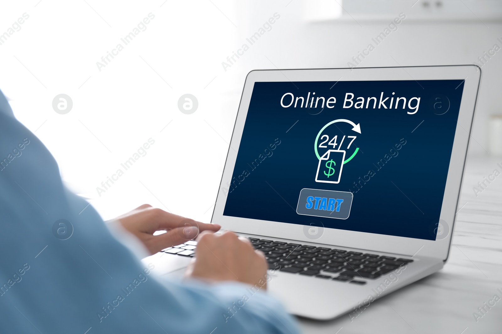 Image of Woman using online banking application on laptop at table, closeup