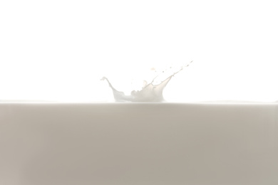 Photo of Fresh milk with splash isolated on white, closeup