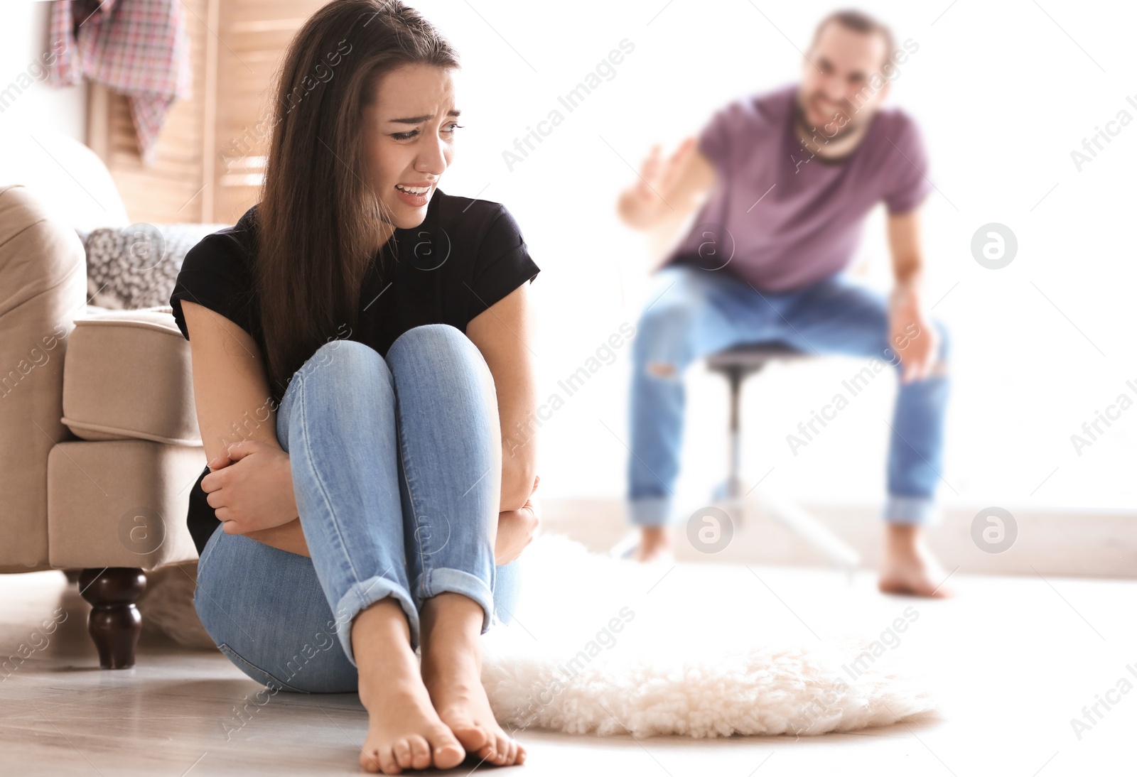 Photo of Young couple having argument in living room