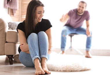 Photo of Young couple having argument in living room