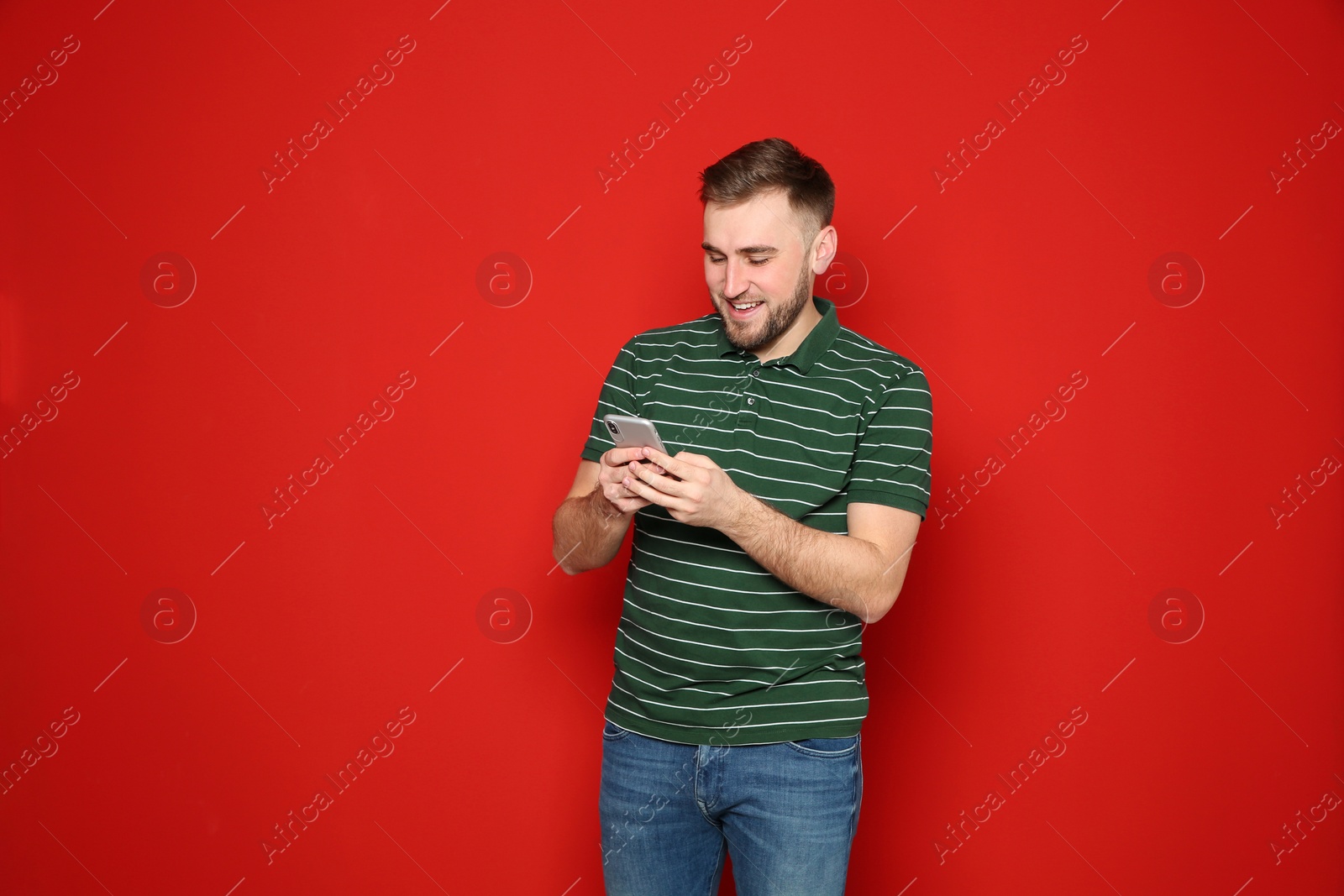 Photo of Portrait of man with mobile phone against color background. Space for text