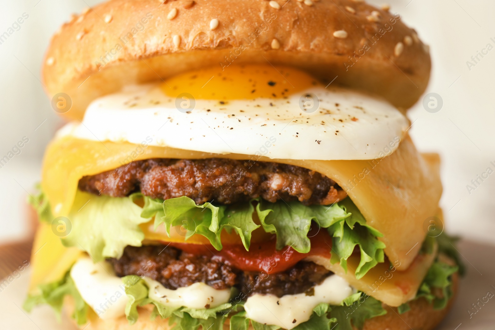 Photo of Closeup view of tasty burger with fried egg