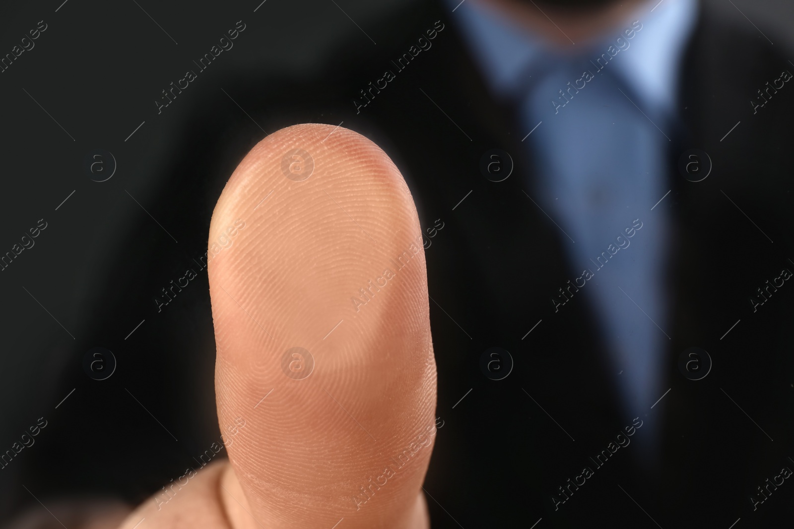 Photo of Businessman pressing control glass of biometric fingerprint scanner, closeup. Space for text
