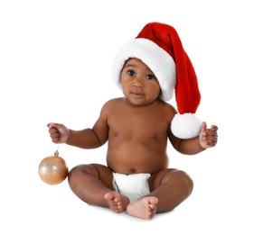 Photo of Cute African-American baby wearing Santa hat with Christmas decoration on white background