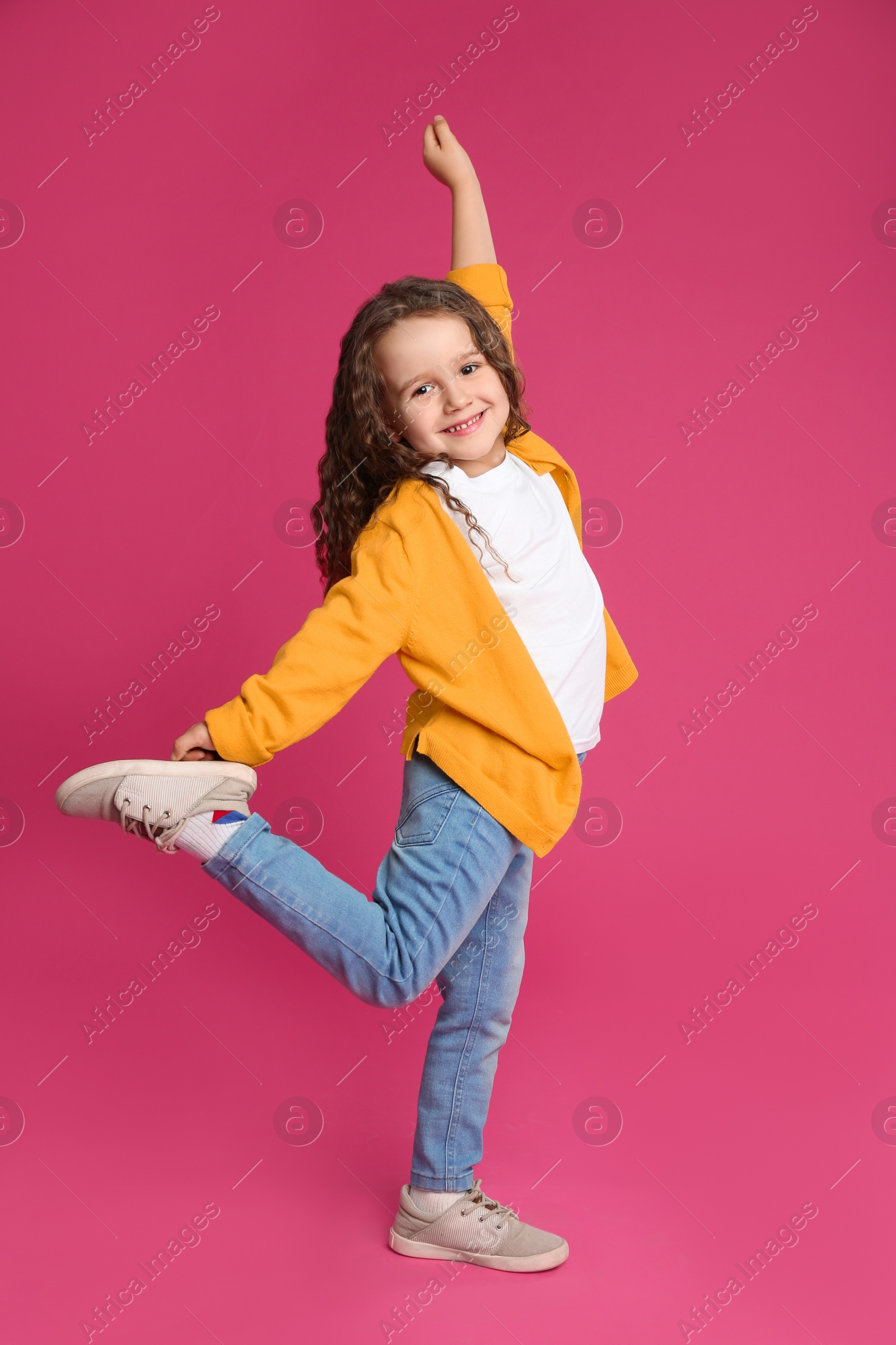 Photo of Full length portrait of cute little girl on pink background