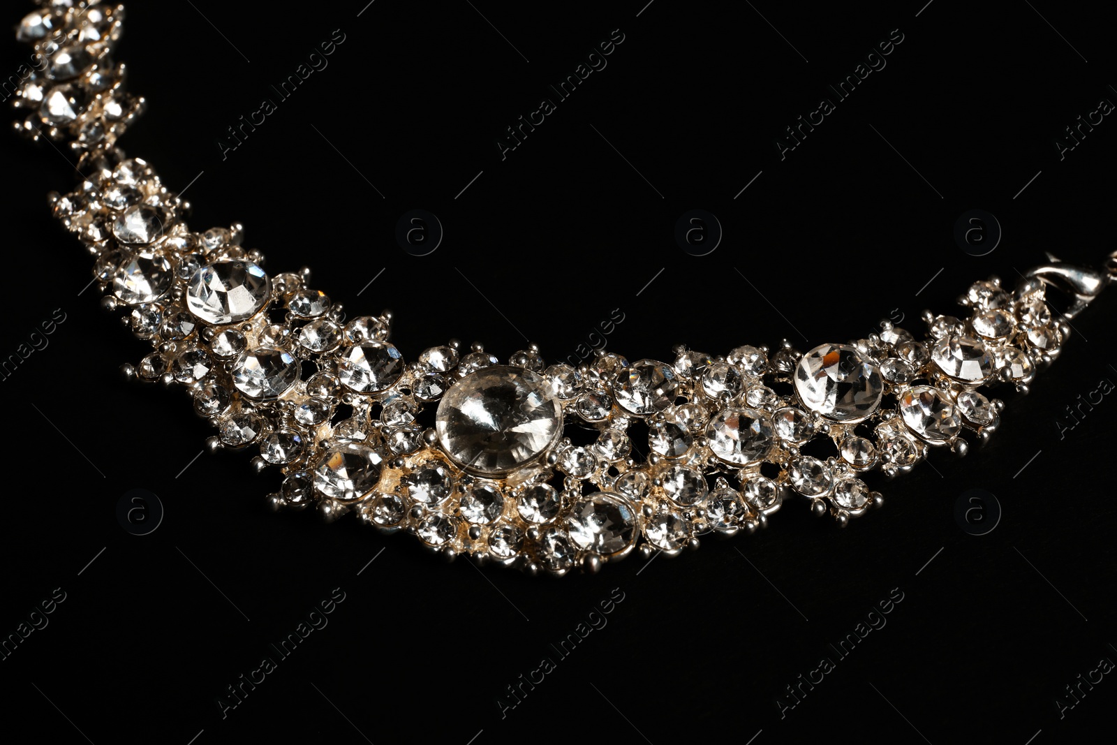 Photo of Stylish necklace on black background, closeup. Luxury jewelry