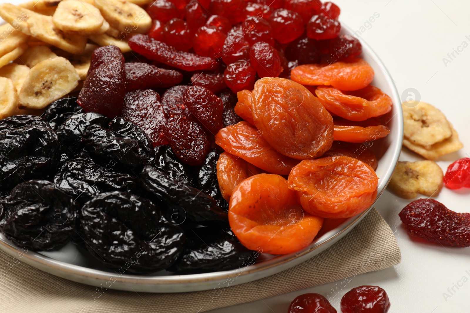 Photo of Delicious dried fruits on white table, closeup