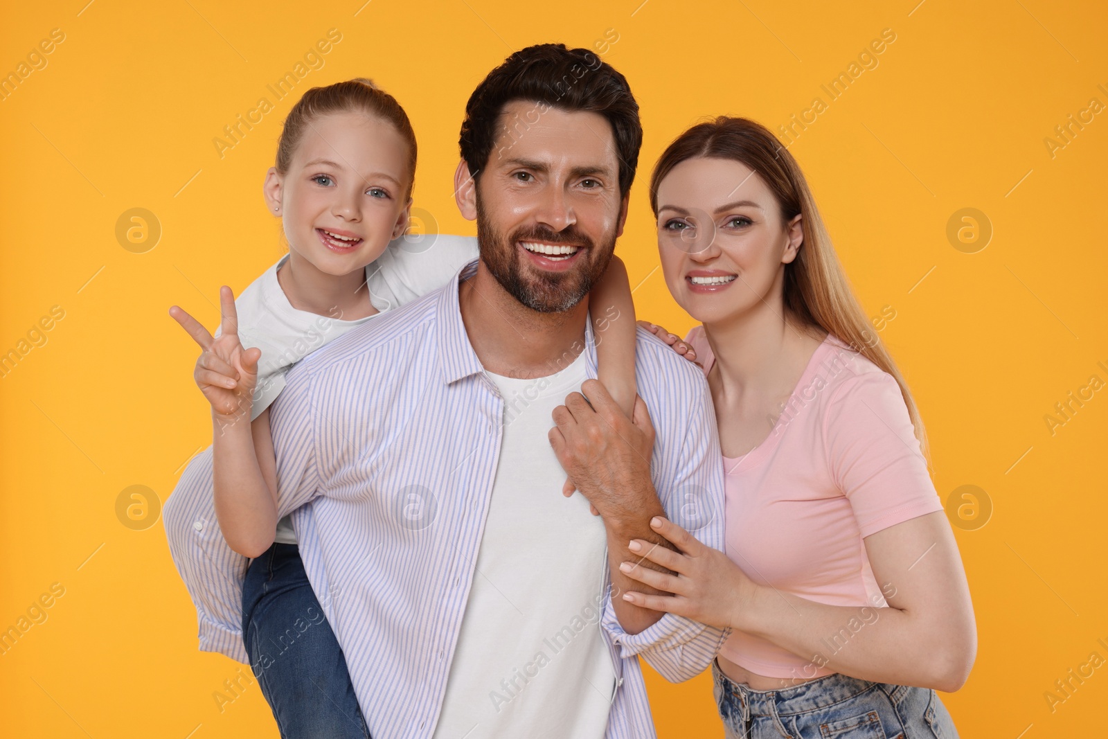 Photo of Portrait of happy family on orange background