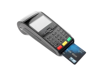Photo of Modern payment terminal with credit card on white background