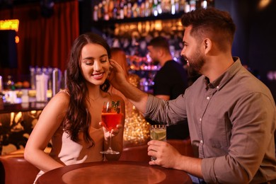 Photo of Lovely couple with fresh cocktails in bar