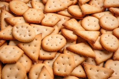 Photo of Many delicious crackers as background, closeup view