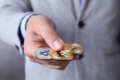 Photo of Man with bitcoins on color background, closeup