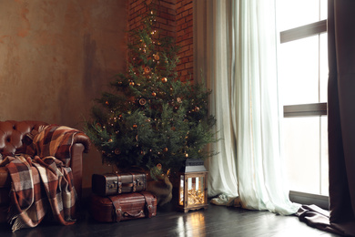Photo of Festive living room interior with decorated Christmas tree