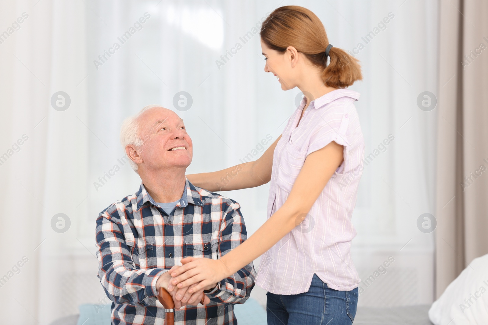 Photo of Elderly man with female caregiver at home