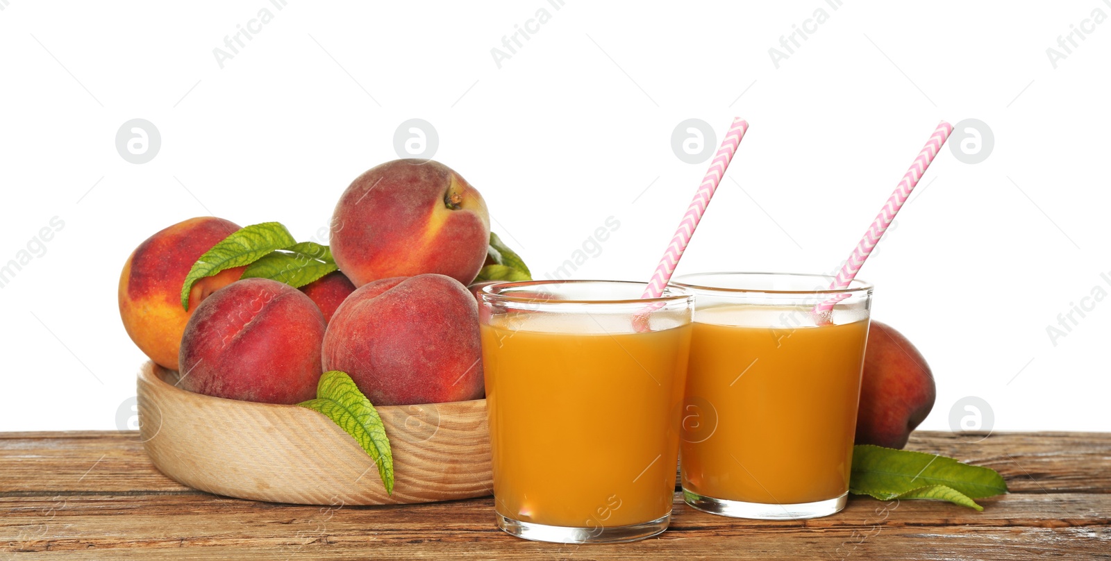 Photo of Natural freshly made peach juice on wooden table, white background