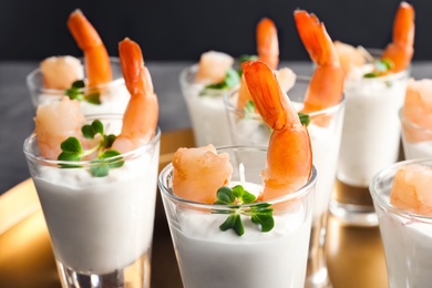 Glasses with boiled shrimps and sauce on tray