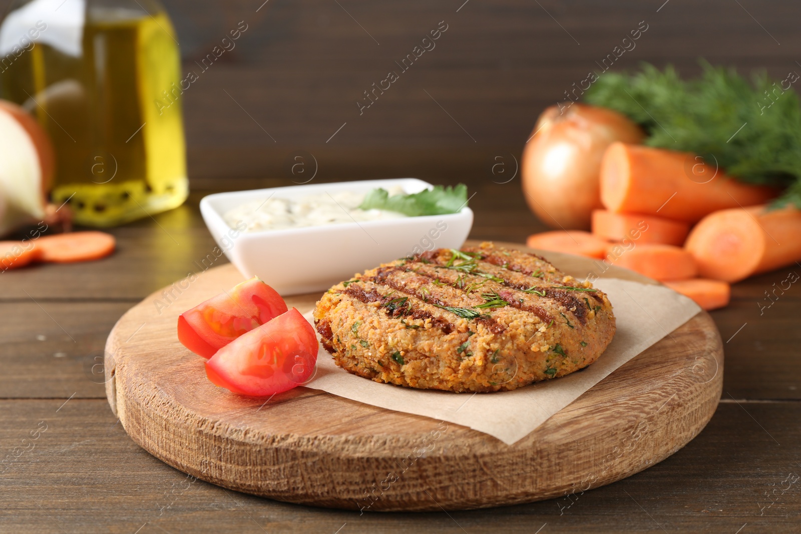 Photo of Delicious vegetarian cutlet served on wooden table