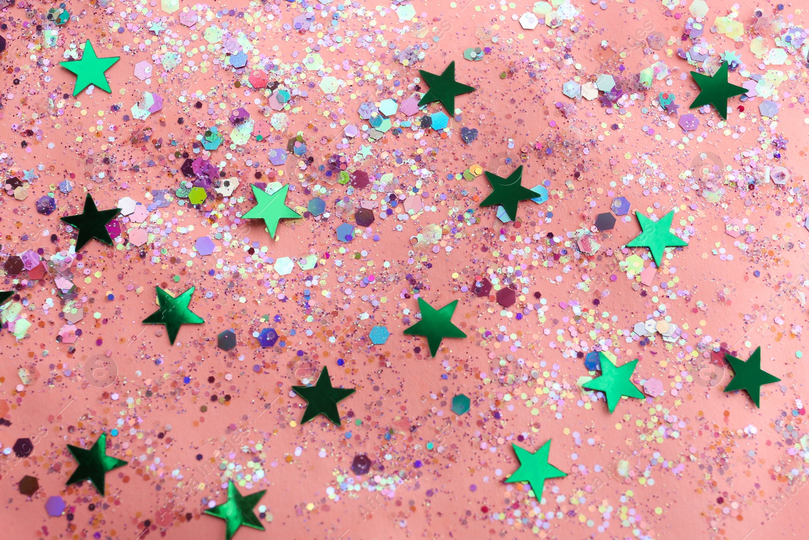 Photo of Shiny glitter on light pink background, flat lay