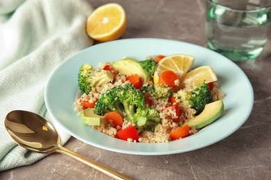 Salad with quinoa in plate on table