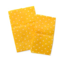 Photo of Yellow reusable beeswax food wraps on white background, top view