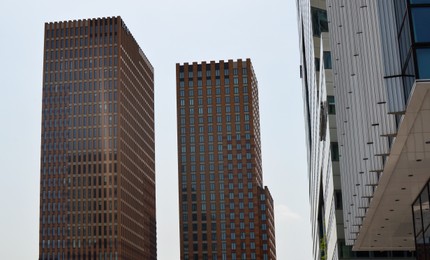 Photo of Exterior of beautiful modern skyscrapers against blue sky