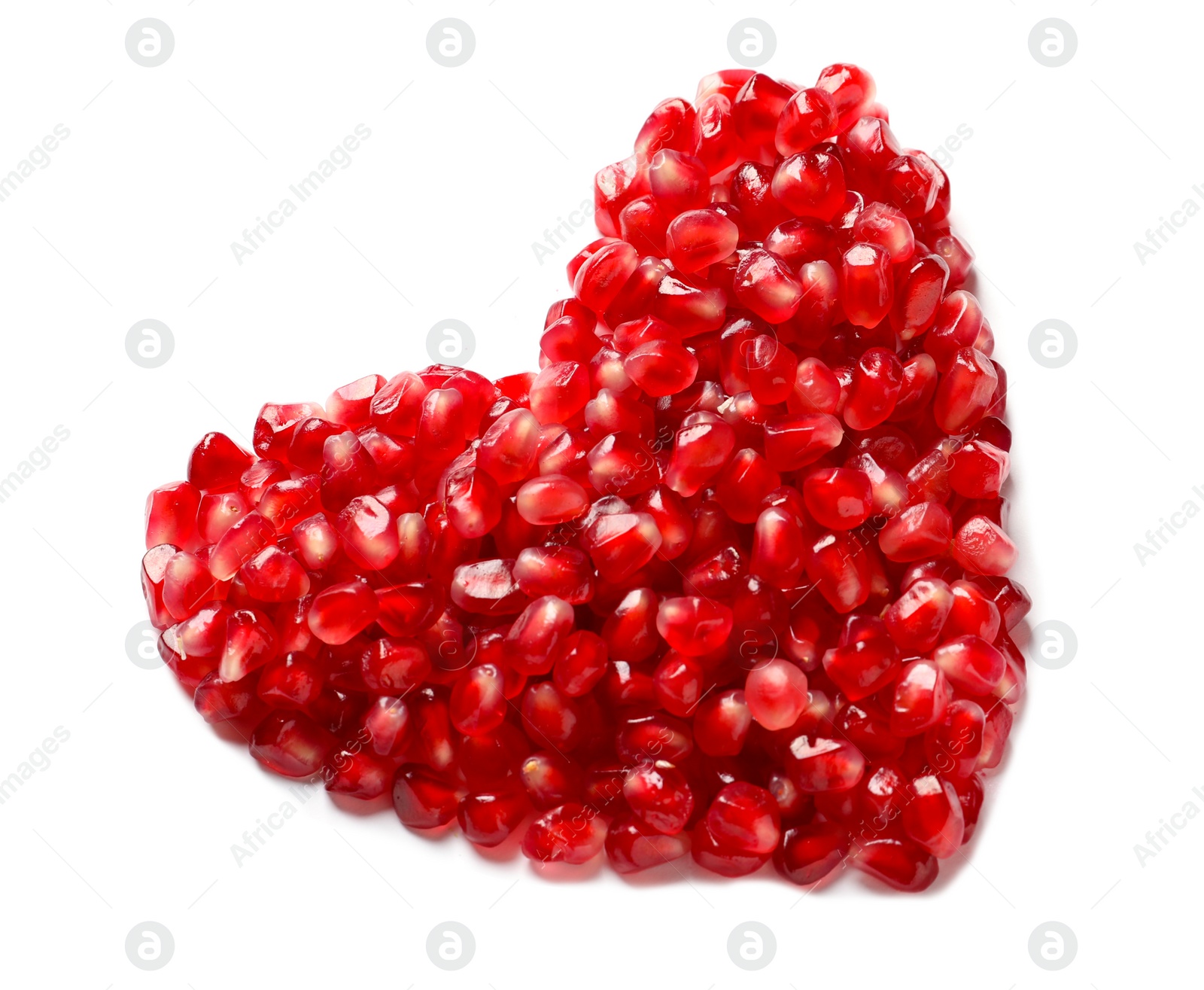 Photo of Heart made of pomegranate seeds on white background, top view. Healthy diet