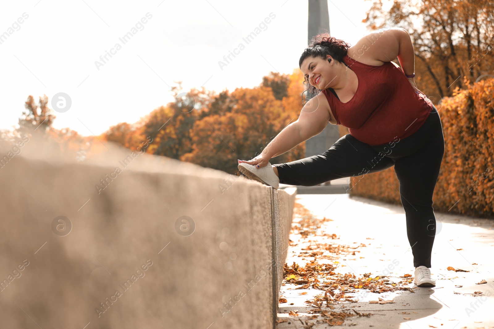 Photo of Beautiful overweight woman doing sport exercises in park