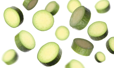 Image of Fresh seedless avocados falling on white background