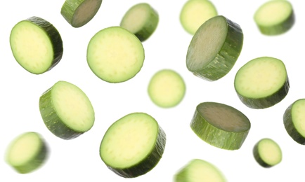 Fresh seedless avocados falling on white background