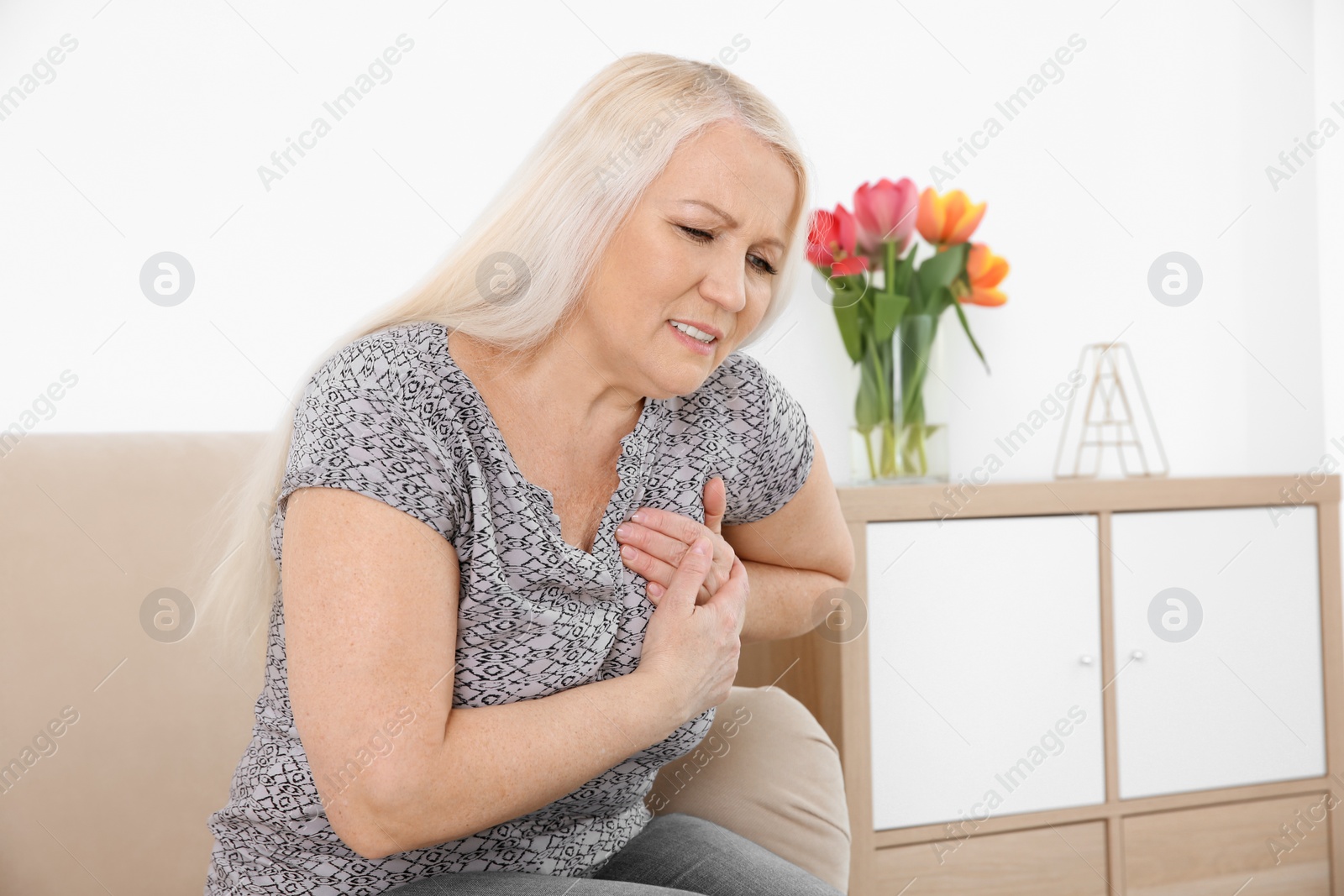 Photo of Mature woman having heart attack at home