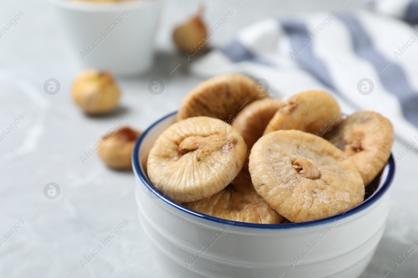 Photo of Tasty dried figs on light grey table, closeup