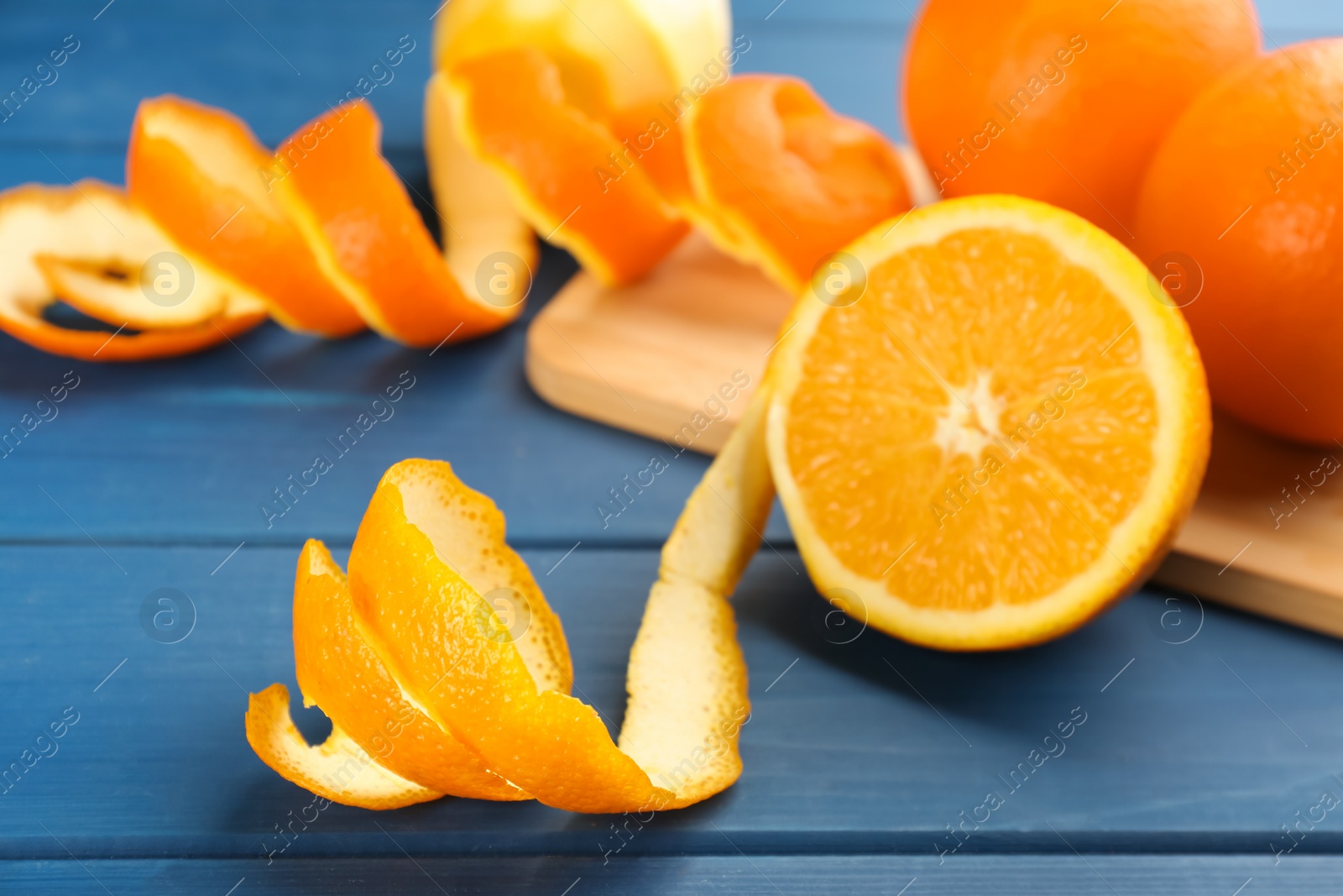 Photo of Orange fruit with peel on blue wooden table