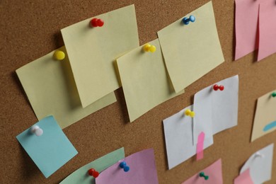 Photo of Colorful paper notes pinned to cork board