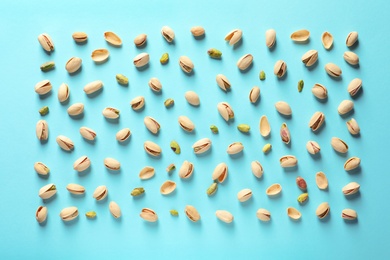 Photo of Composition with organic pistachio nuts on color background, flat lay