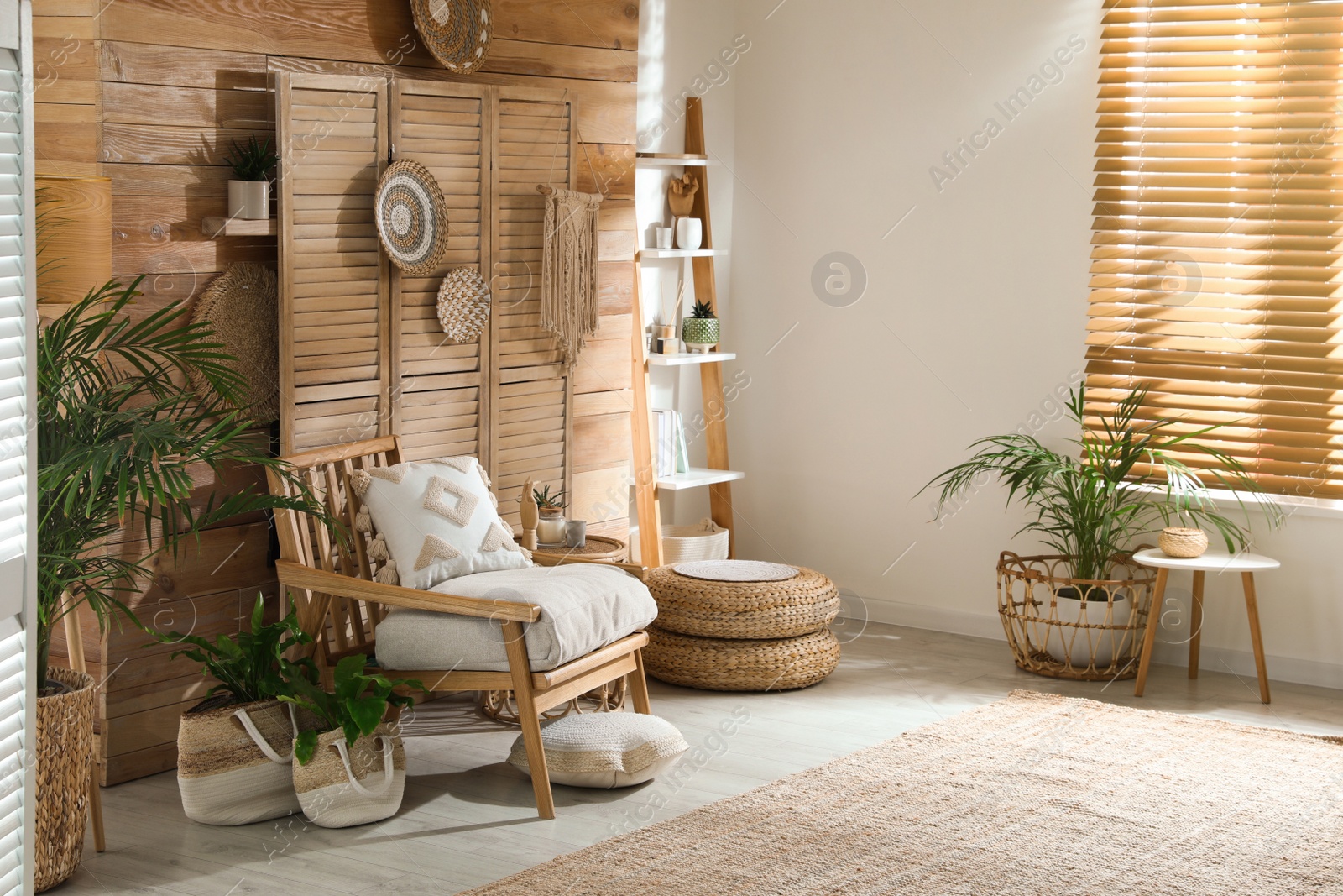 Photo of Stylish living room interior with comfortable wooden armchair and beautiful houseplants