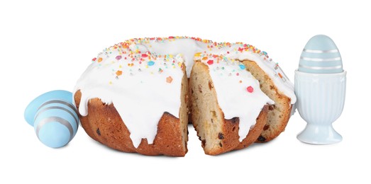 Photo of Traditional Easter cake with sprinkles and festively decorated eggs on white background