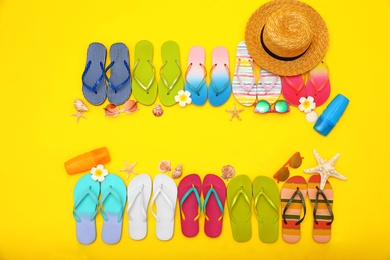 Photo of Flat lay composition with summer beach accessories on yellow background. Space for text