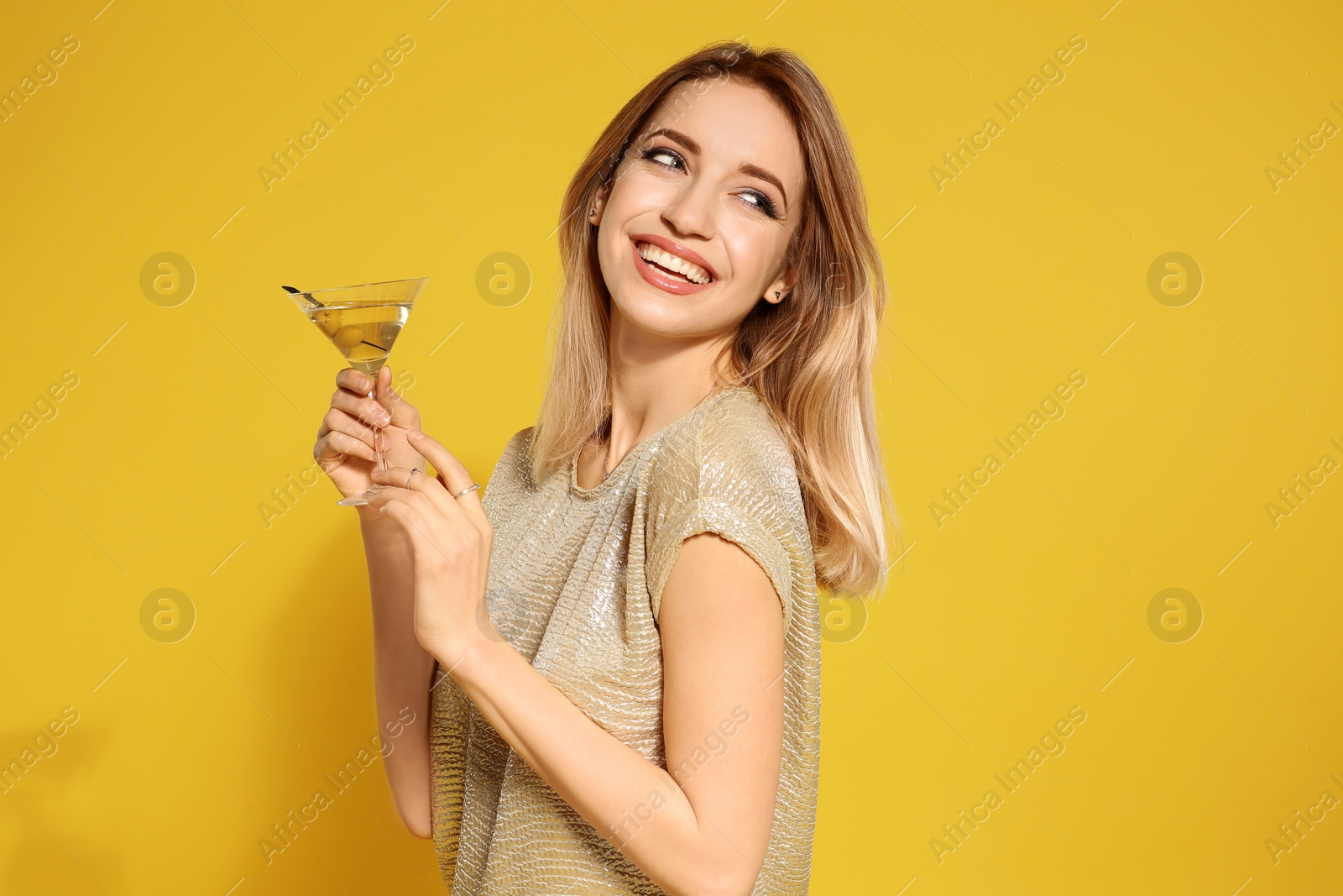 Photo of Beautiful young woman with glass of martini cocktail on color background