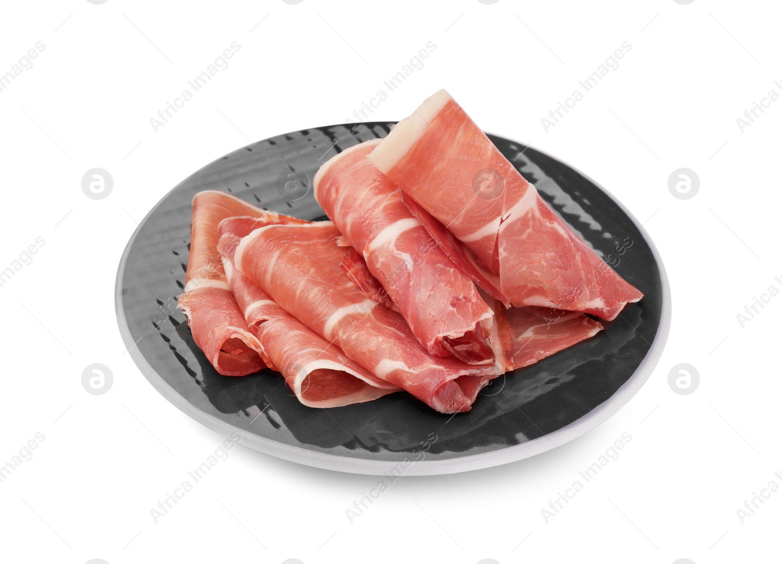 Photo of Plate with rolled slices of delicious jamon isolated on white