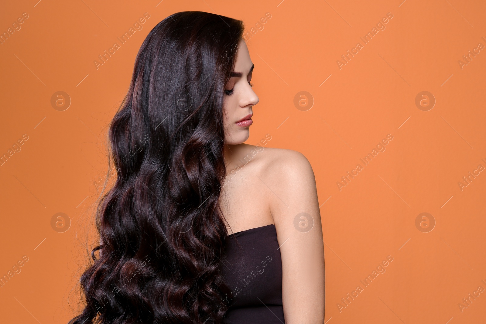 Photo of Portrait of beautiful model with gorgeous curly hair on color background