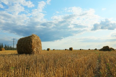 Beautiful view of agricultural field with hay bales